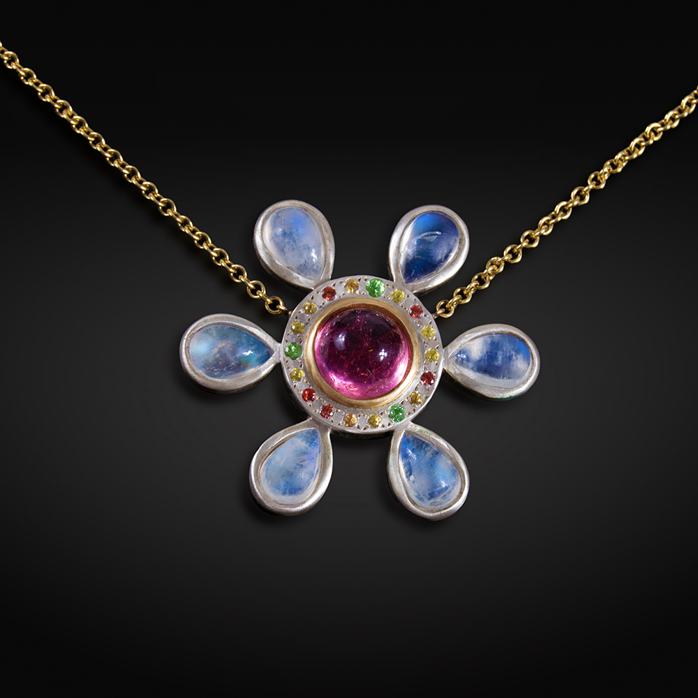 Brushed 18K and silver necklace with flower containing Moonstones, Pink Tourmaline, orange and yellow Sapphires, and Tsavorite Garnets